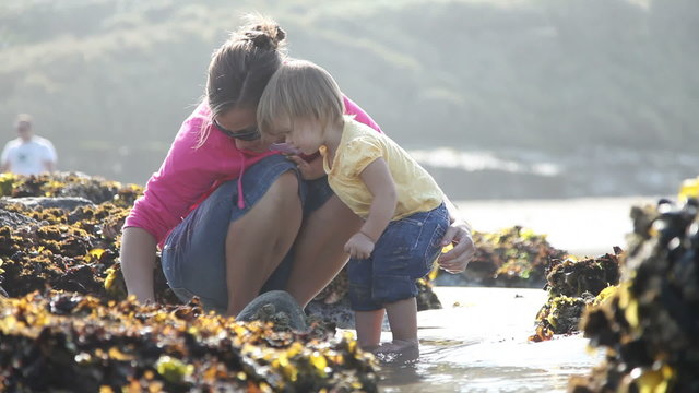Mother and daughter looking in tide pools