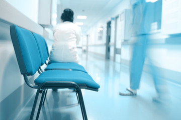Female doctor sitting alone in the hospital hall