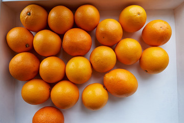 A lot of oranges on a white tray