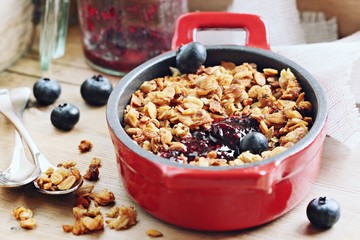 Blueberry granola crisp. Clean-eating gluten free dessert . Superfoods concept.Toned image, selective focus