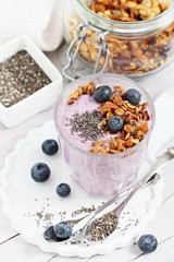 Overnight chia seeds and blueberry yogurt with homemade granola.Healthy eating concept.Selective focus
