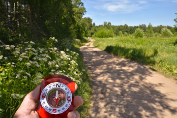 With compass on the walk.