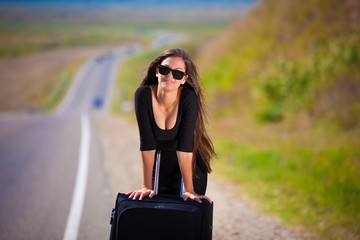Fototapeta premium brunette woman road suitcase