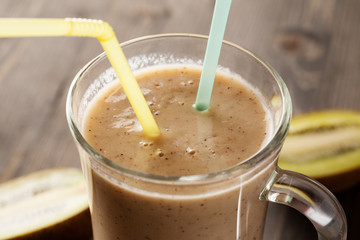 Fruit smoothie with two straws in it closeup