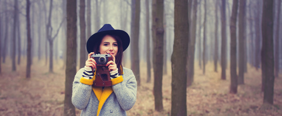 portrait of a young woman with a camera