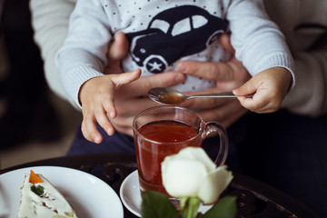 Portrait of happy young family having breakfast in the cafe. Concept of the happy family and funny time together
