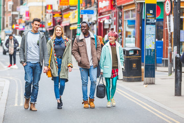 Group of young friends walking in London - obrazy, fototapety, plakaty
