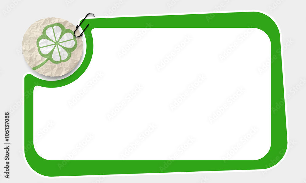 Poster frame and crumpled slip of paper and cloverleaf