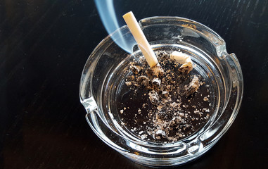Still life cigarette and glass ashtray