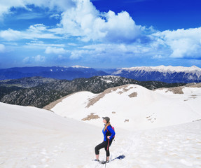 Fototapeta na wymiar Girl hiking .Snow on the top of the Tahtali mountain in Turkey