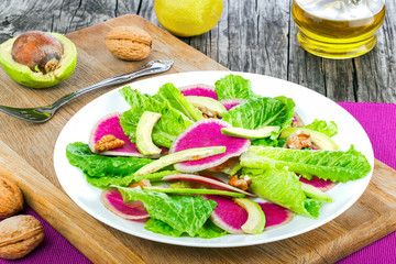 salad with watermelon radish, cos lettuce, avocado slices and wa