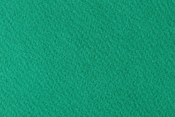 Textured dark green paper as background.