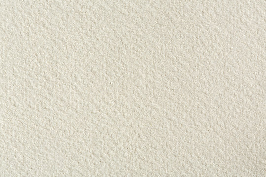 Water-colour paper texture background in light beige tone.