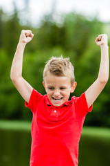 Happy boy with raised arms