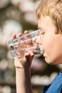 Boy holding glass of fresh water