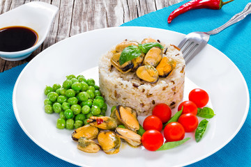 marinated mussels with brown rice, cherry tomatoes, green peas