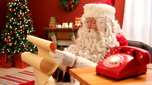 Santa Claus talking on retro telephone