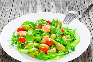 tuna salad with arugula, green olives, avocado and cherry tomato