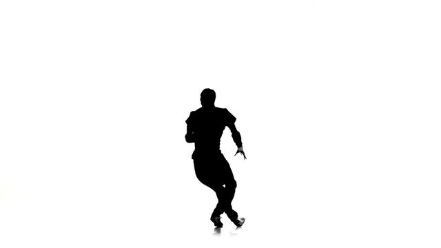 Man dancing breakdance professionally moves and turns, white, silhouette, slow motion