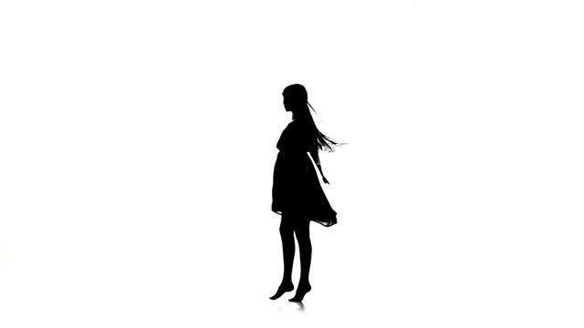 Graceful girl dancer dancing contemporary dance on white, silhouette, slow motion