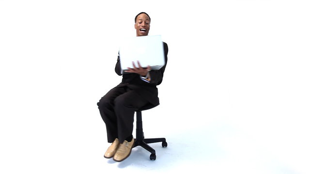 Businessman with laptop spinning in chair