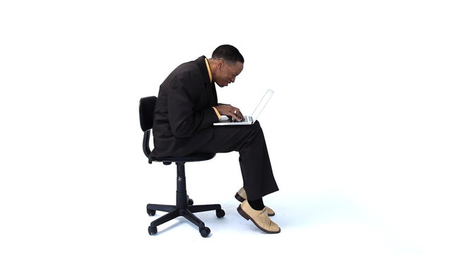 Businessman in chair with laptop computer