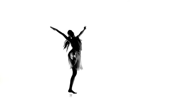 Slim woman with ponytail dance modern contemporary style makes split on white, silhouette, slow motion