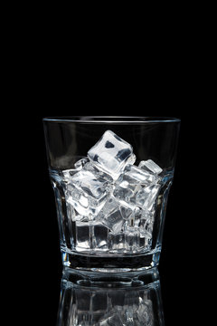 glassful for whiskey with ice cubes isolated on black background