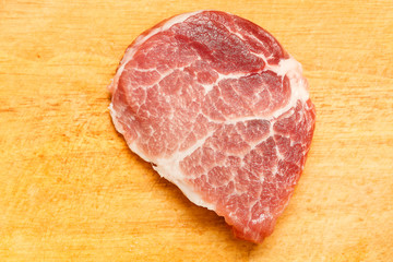 juicy piece of fresh meat on a wooden background, close-up