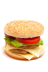 big hamburger with sesame seeds, fresh vegetables and juicy meat