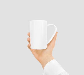 White blank mug mock up holding hand isolated. Empty ceramic tea cup hold handle. Clear drink mug mockup ready for logo design presentation. Teacup pot holder.