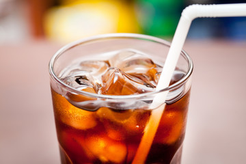 glass of cola with ice on the bar