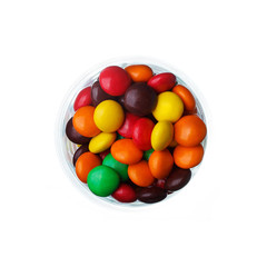 multi colored caramel sweets and chocolate candies in glass isol