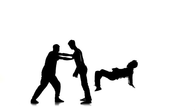 Three young men dancing hip-hop, breakdance on white, silhouette, slow motion