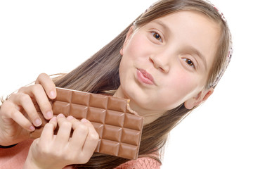 preteen  girl eats chocolate, isolated on white