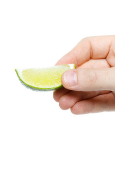 lime in hand isolated on white background