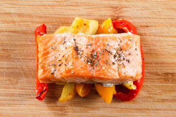 Grilled salmon fillet with vegetables and spices n a plate