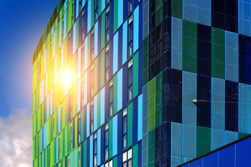 blue-green glass commercial  fañade with sunlight