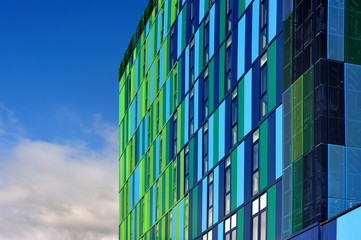 Glass colorful facade with cloudy sky