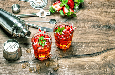 Red drink with ice. Cocktail making tools vintage
