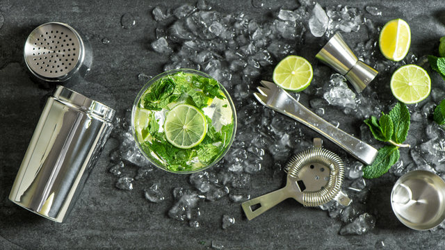 Glass cocktail lime, mint, ice. Drink making bar tools shaker