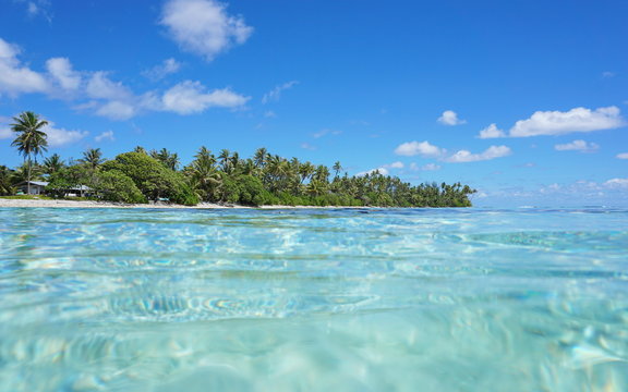 Tropical shore with turquoise water near Maeva village of Huahine island, seen from the ocean surface in the lagoon, Pacific, French Polynesia