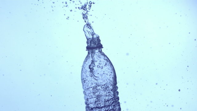 Water splashing out of bottle, slow motion