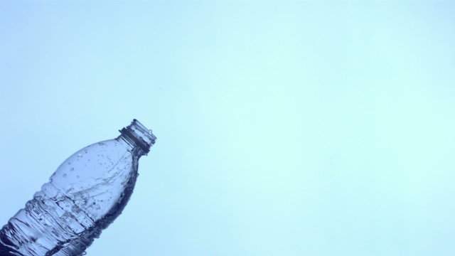 Water splashing out of bottle, slow motion