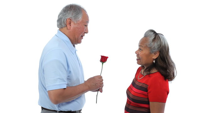 senior man with rose giving to woman