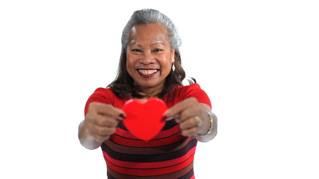 Senior woman holding hearts