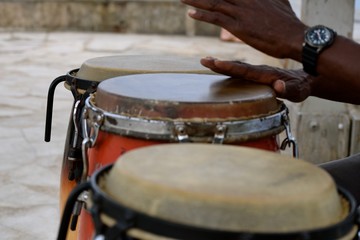 Conguero / Hands of a congo drum player, the conguero, playing at the end of the pier in Waikiki...