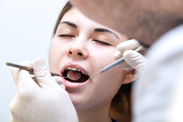 dentist in a dental clinic. The girl on reception at the dentist's chair.