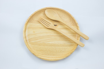 wooden plate with spoon fork top view on white background