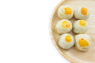 Chinese Pastry Mung Bean or Mooncake with Egg Yolk on wooden dish